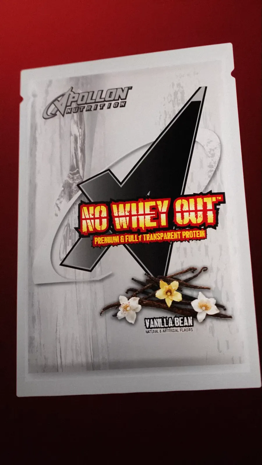 A white No Whey Out vanilla bean protein sachet floats with vanilla flowers.