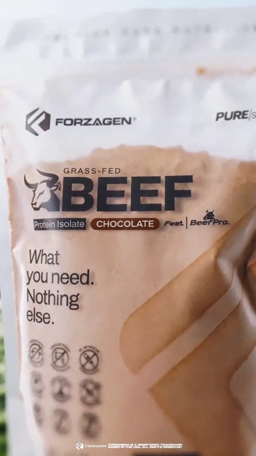 Macro front-label view of a Forzagen grass-fed Pure Beef chocolate protein bag.