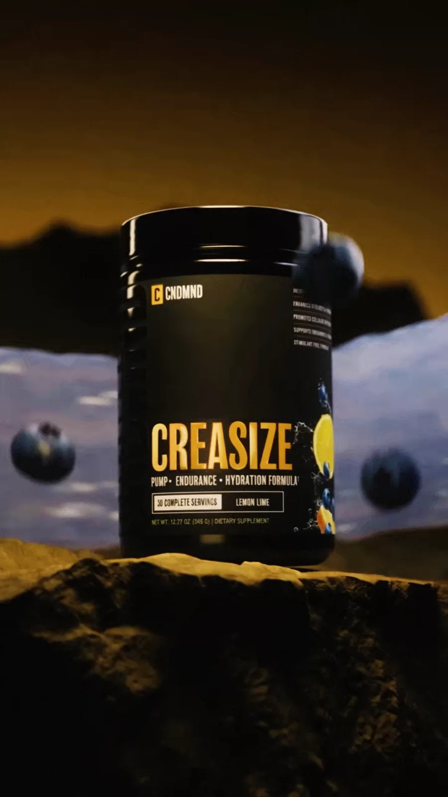Creasize Blueberry Lemonade tub standing on amber rock with a pale liquid wave behind it.