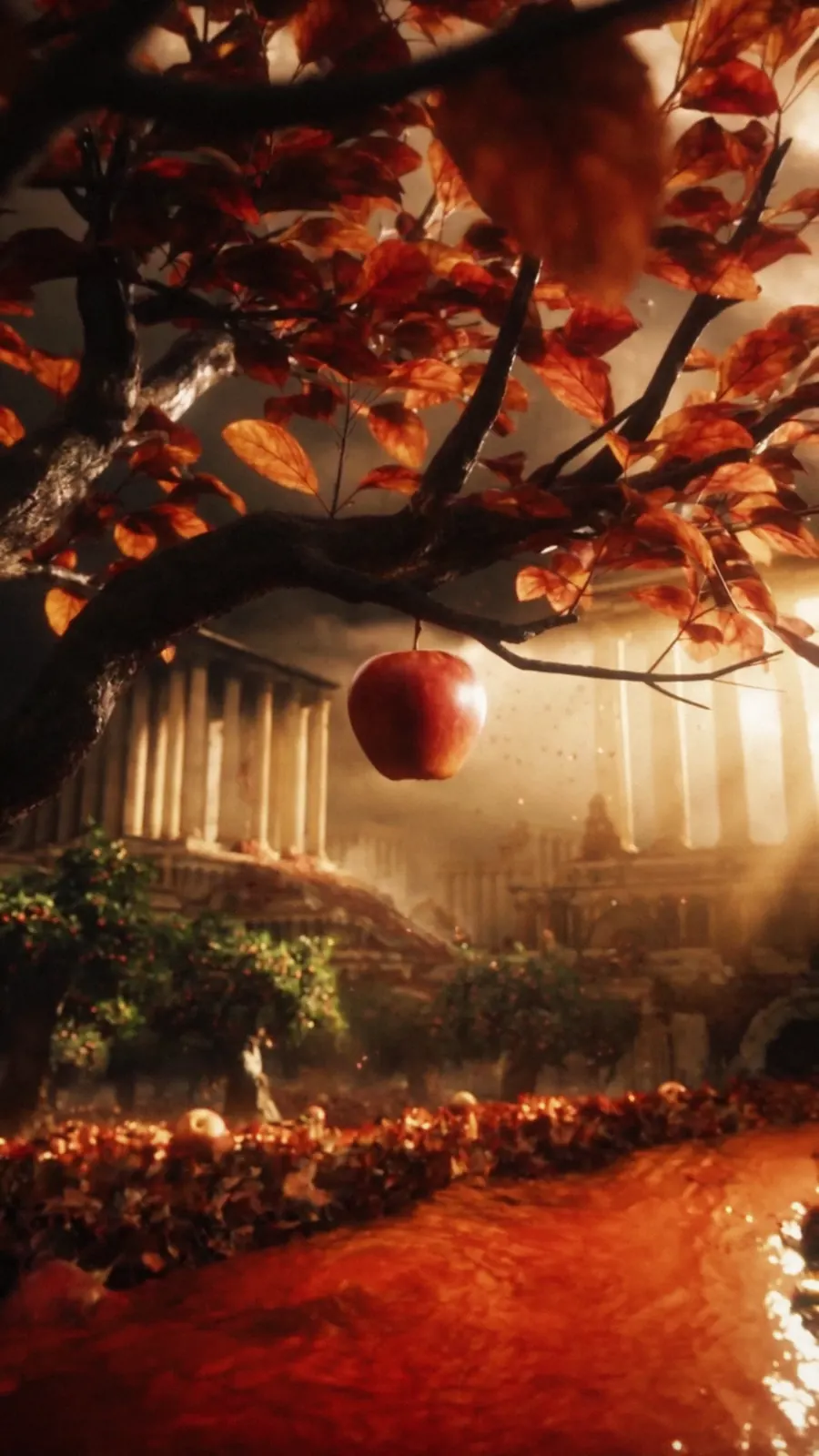 Red apple hanging from a branch in a glowing cinematic autumn orchard.