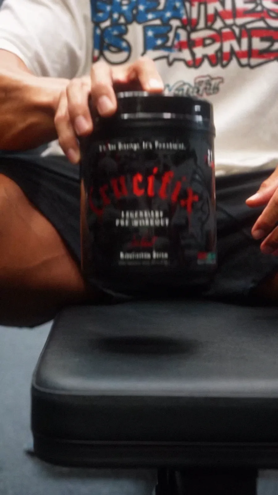 Black NutriFitt Crucifix Legendary Pre-Workout tub held upright on a gym bench.