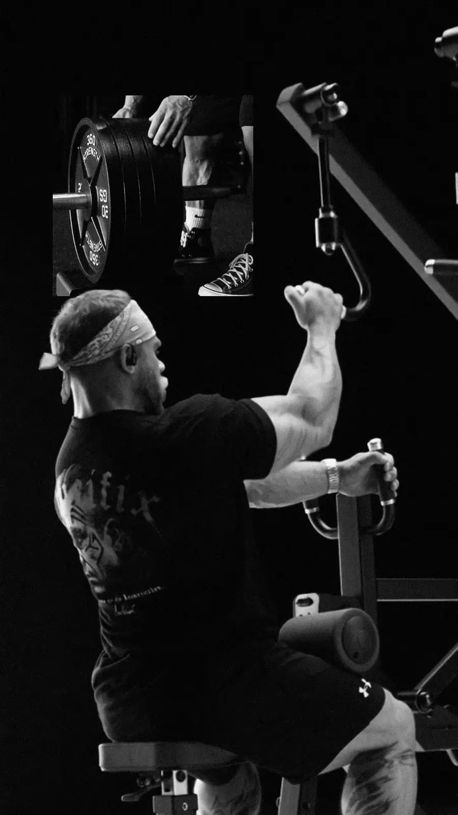 The athlete pulls a single-arm row on a plate-loaded machine.