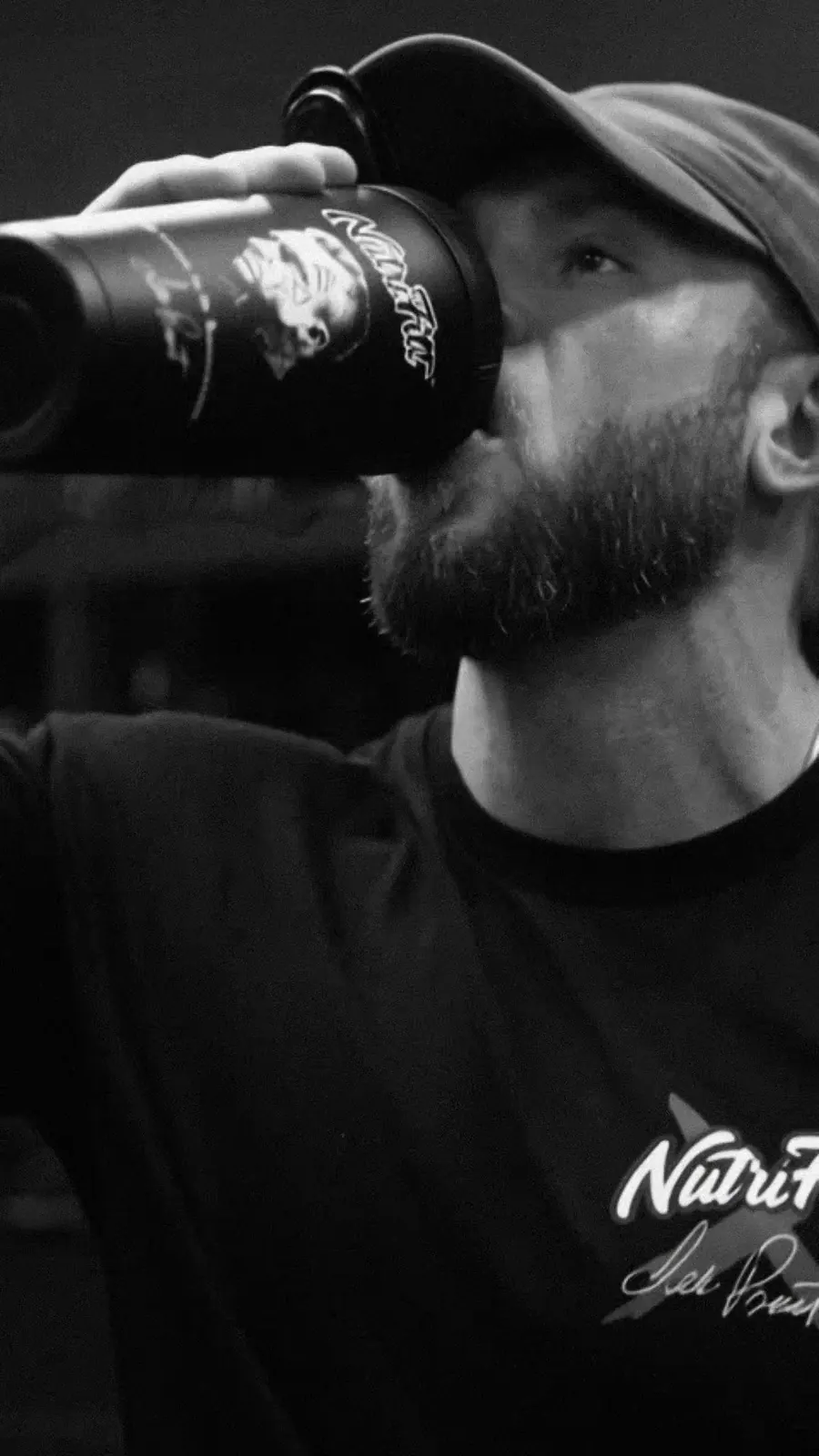 The athlete drinks from a black NutriFitt shaker.