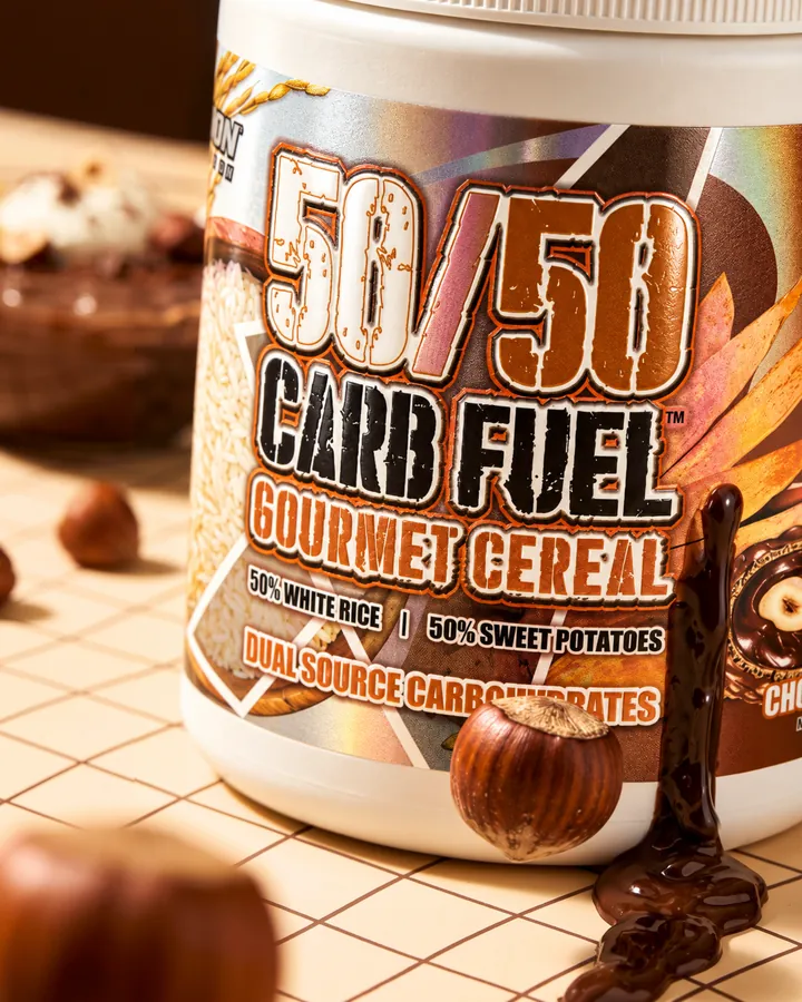 Close-up of the 50/50 Carb Fuel Gourmet Cereal label with chocolate dripping and hazelnuts in the foreground.