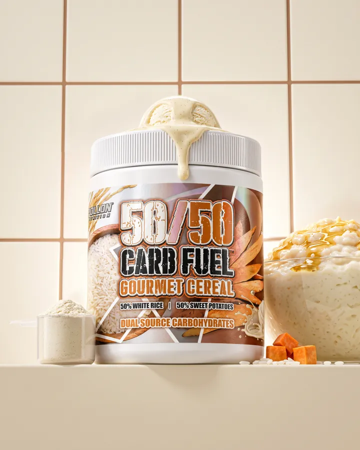 A 50/50 Carb Fuel tub with a vanilla drizzle on a cream tiled set beside a vanilla cereal cup and a scoop.