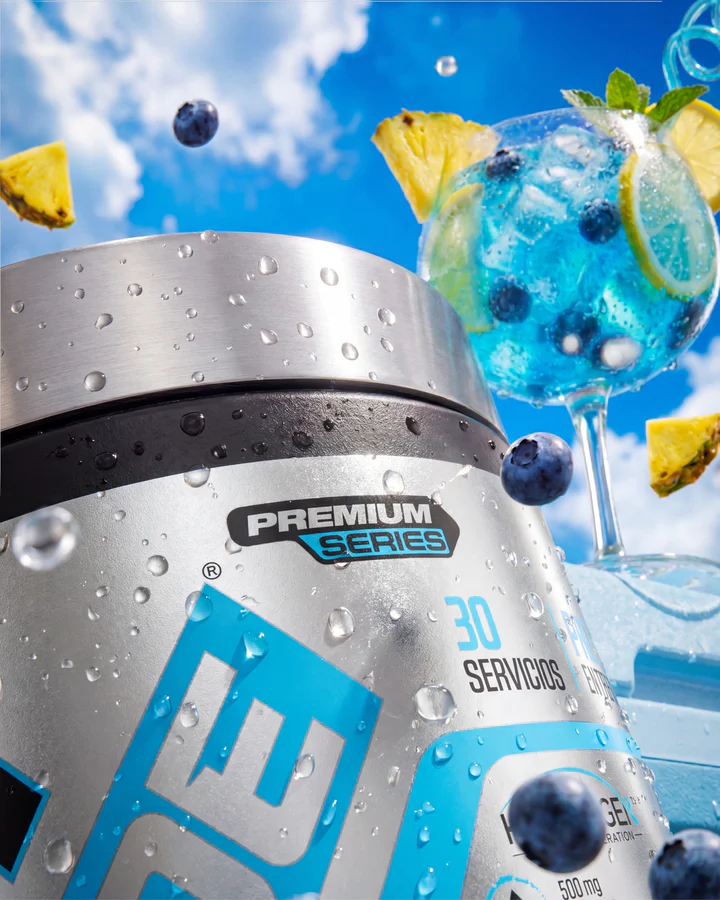 Blue CREA LADE tub rises from ice and splashing blue drink with blueberries and pineapple around it.