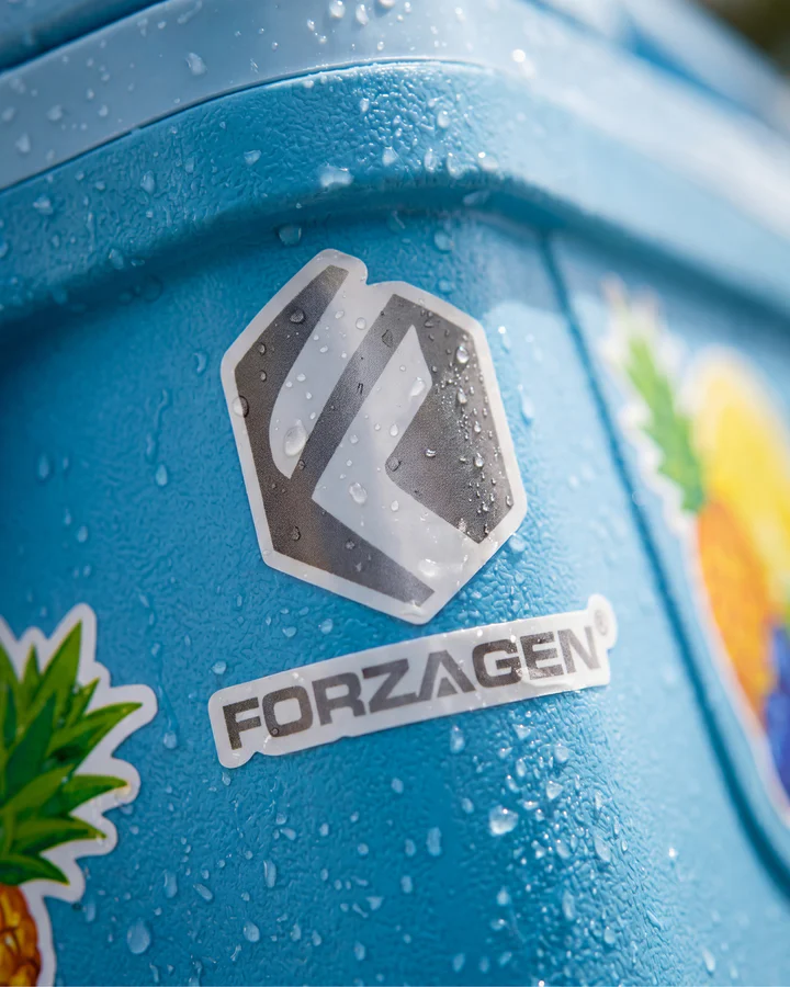 Macro view of a cold blue Forzagen shaker filled with bright-blue liquid and water droplets.