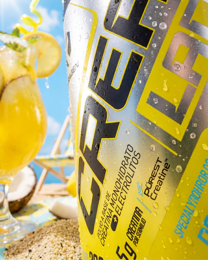 Wet yellow Forzagen CREA LADE tub fills the frame beside a tropical yellow drink, lemon and coconut.