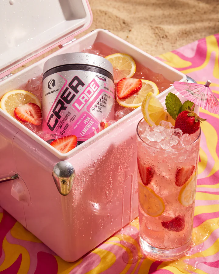 Pink CREA LADE tub rests in an ice-filled cooler with strawberries, lemon and a tall pink lemonade.