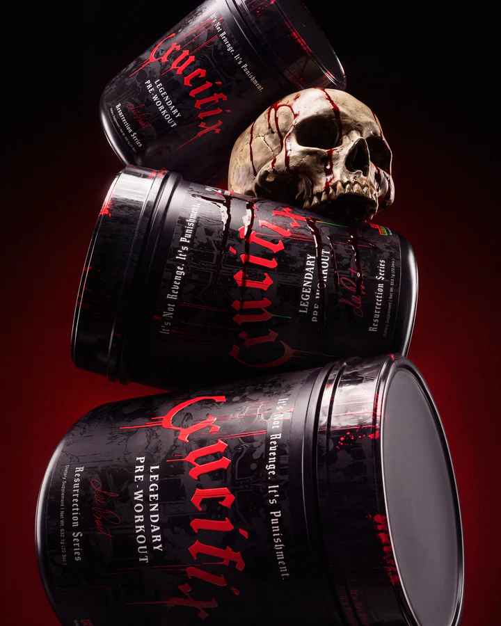 Three Crucifix Legendary Pre-Workout tubs stack around a skull against a black-and-red background.
