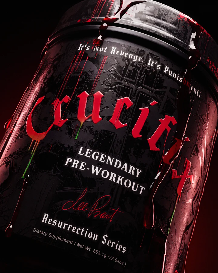 Extreme close-up of a wet black Crucifix tub centers the distressed red logo and Legendary Pre-Workout label.