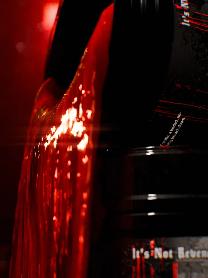 Macro of thick blood pouring over the lip of an open Crucifix tub.