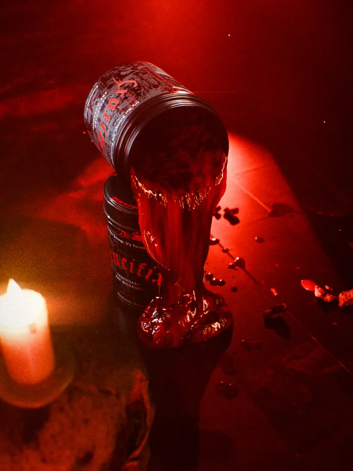 View down onto the altar from behind lit candles, blood pouring from an open Crucifix tub.