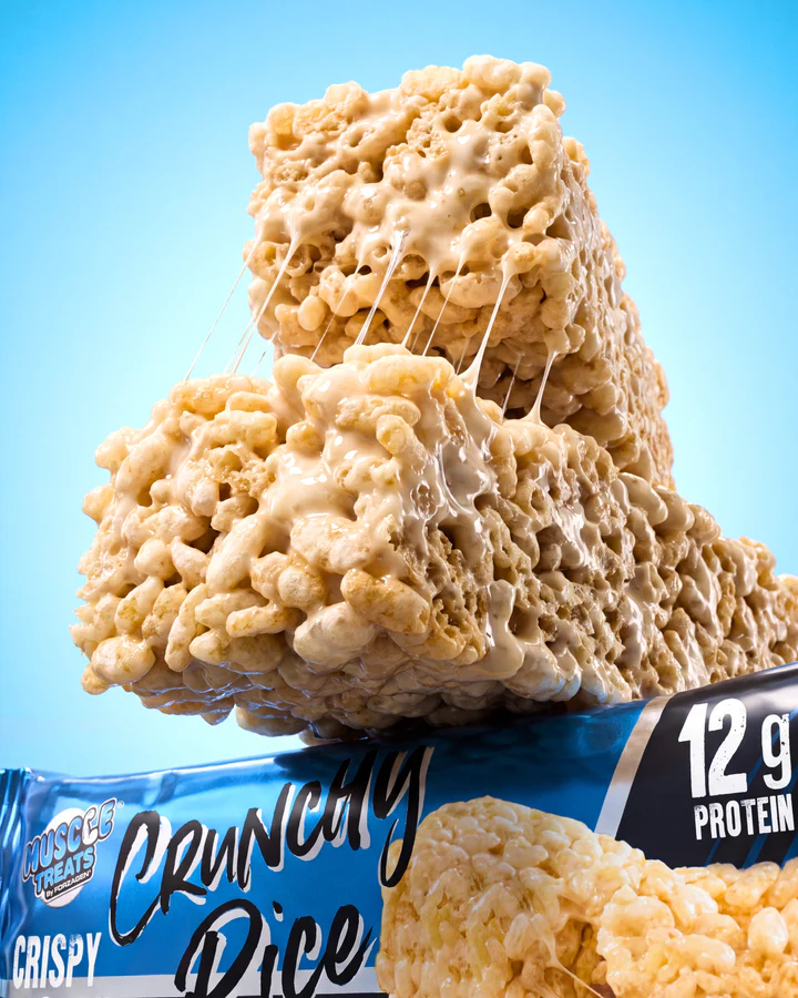 Two large rice-crisp snack pieces stack above a blue Crunchy Rice wrapper against a bright-blue background.
