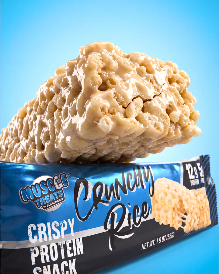 A single rice-crisp protein snack piece hovers above a close Crunchy Rice wrapper marked 12G Protein.