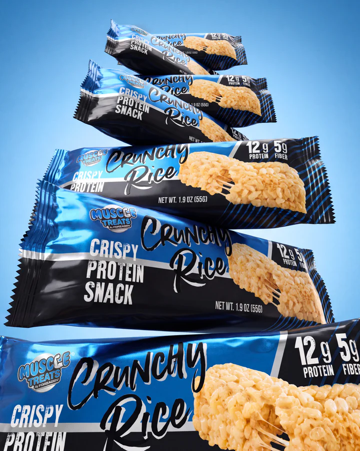 A pile of blue Crunchy Rice wrappers forms a product stack on a saturated-blue studio set.