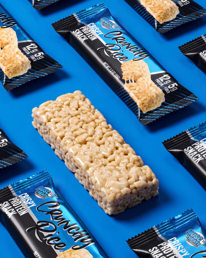 Blue Crunchy Rice wrappers and one unwrapped rice-crisp snack form a geometric flat lay.