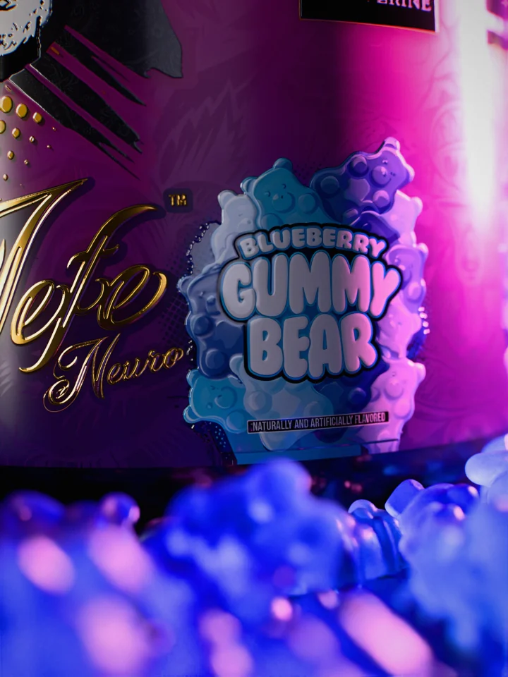 Macro of the Blueberry Gummy Bear flavor badge on the El Jefe Neuro label with blue gummy bears out of focus in front.