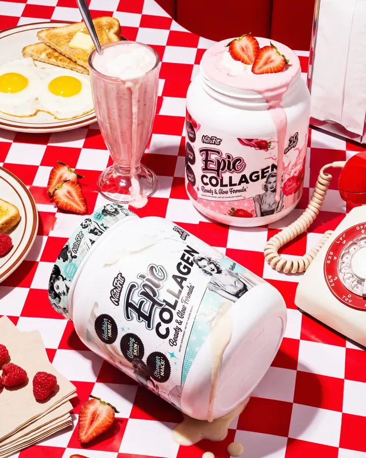 NutriFitt Epic Collagen Pink Berries and Unflavored tubs on a red-and-white diner table with a strawberry shake, breakfast plates, berries and a rotary phone.