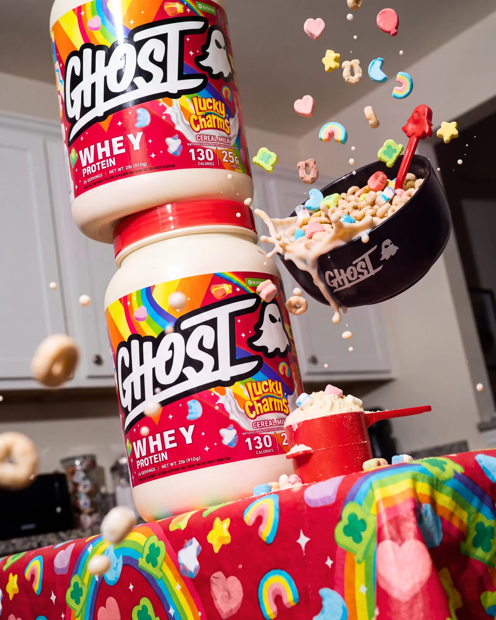 Ghost Lucky Charms whey tubs and cereal suspended above a colorful breakfast table.