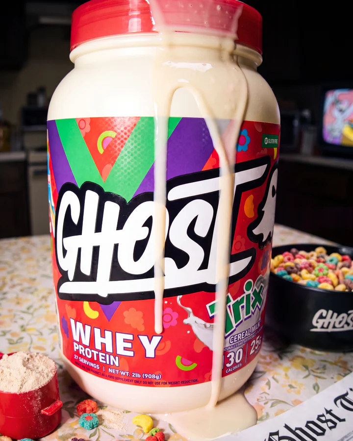 Close hero view of a Ghost x Trix whey tub with cereal and a black Ghost bowl behind it.