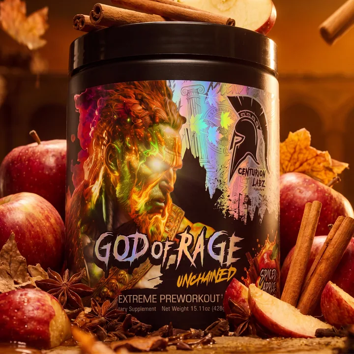 Close frontal view of the God of Rage Spiced Apple Cider tub among apples, cinnamon and autumn leaves in warm amber light.
