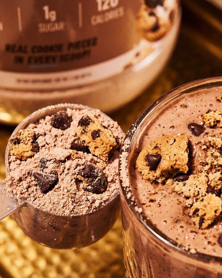 ISOCLUSIONS Overhead detail of a chocolate protein scoop and cookie-topped chocolate shake.