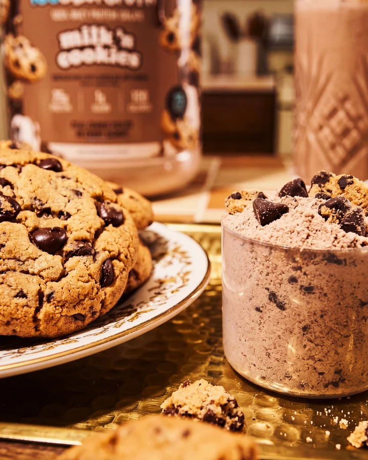 ISOCLUSIONS Chocolate chip cookies and a filled scoop in front of the Milk 'n Cookies tub.