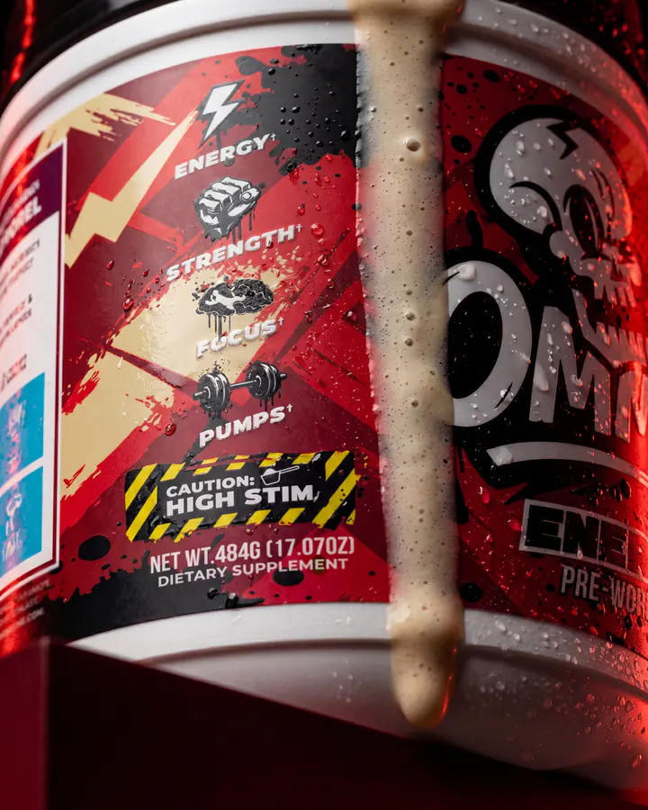 Macro view of the Ommi Energy Cherry Pop Cream label with cream flowing over the tub.