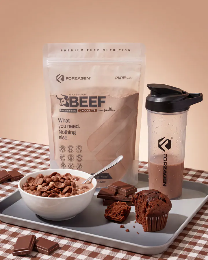 Forzagen Pure Beef Chocolate protein bag and shaker staged with chocolate cereal, brownies and a striped straw.