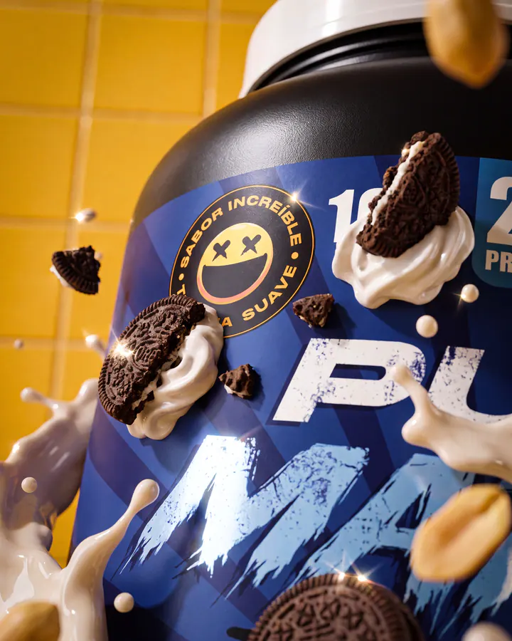 Close-up Pure Matrix tub with cookies, cream and peanuts suspended around the label.