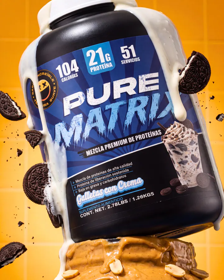Pure Matrix cookies-and-cream protein tub surrounded by a milk splash, cookies and peanuts.