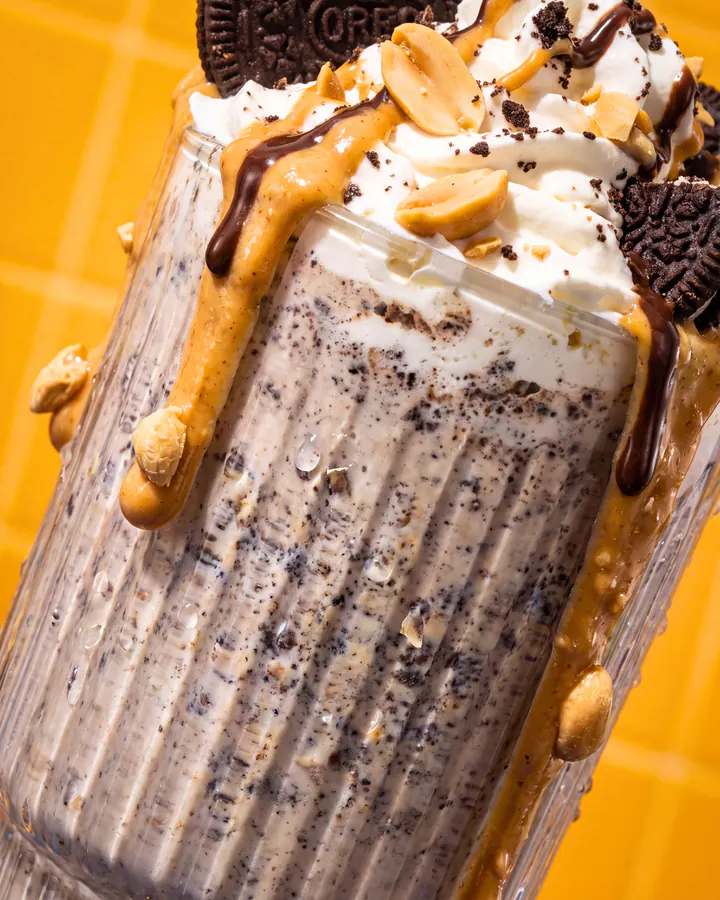 Cookies-and-cream protein shake topped with whipped cream, cookies and peanut butter.