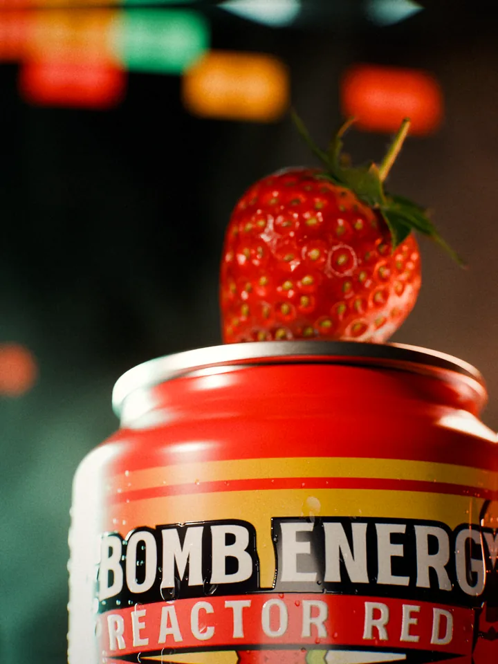 Macro of a strawberry resting on the lid of the Reactor Red can above the title, colored control lamps blurred behind.